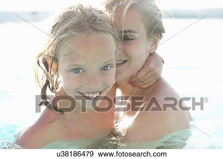 Portrait of mother and daughter in outdoor swimming pool View Large Photo Image Stock Photo - Portrait of mother and daughter in outdoor swimming pool. Fotosearch
