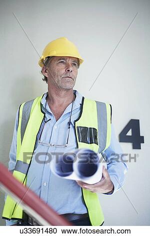 Portrait of senior male architect holding blueprints View Large Photo Image Stock Image - Portrait of senior male architect holding blueprints. Fotosearch