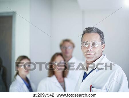 Stock Image - Portrait of senior male scientist wearing safety glasses. Fotosearch