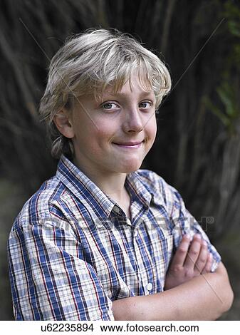 Portrait of smiling boy with arms folded View Large Photo Image Picture - Portrait of smiling boy with arms folded. Fotosearch