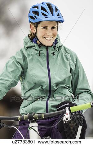 Portrait of smiling mid adult female mountain biker on bike View Large Photo Image Stock Image - Portrait of smiling mid adult female mountain biker on bike. Fotosearch