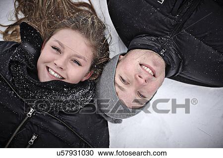 Portrait of teenage girl and her brother lying in snow View Large Photo Image Stock Image - Portrait of teenage girl and her brother lying in snow. Fotosearch