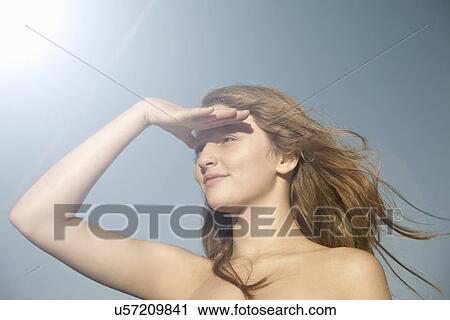 Portrait of teenage girl shielding her eyes from the sun View Large Photo Image Stock Image - Portrait of teenage girl shielding her eyes from the sun. Fotosearch