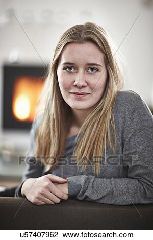 Stock Image - Portrait of teenage girl smiling apprehensively. Fotosearch