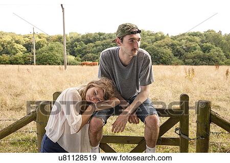 Portrait of young couple with field in background View Large Photo Image Stock Photo - Portrait of young couple with field in background. Fotosearch