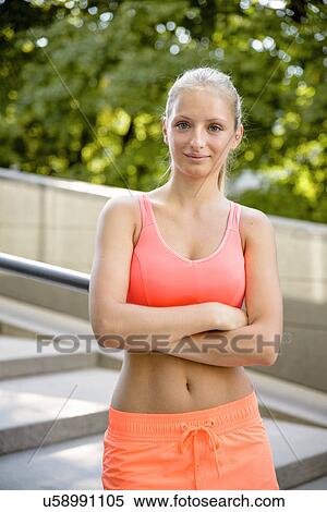 Portrait of young female runner with arms folded View Large Photo Image Stock Photography - Portrait of young female runner with arms folded. Fotosearch