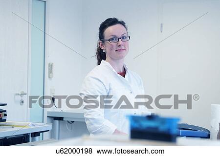 Stock Photo - Portrait of young female scientist in laboratory. Fotosearch