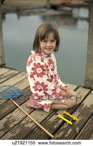 Portrait of young girl on pier with fishing net, Southwold, Suffolk, UK View Large Photo Image Stock Photography - Portrait of young girl on pier with fishing net, Southwold, Suffolk, UK. Fotosearch