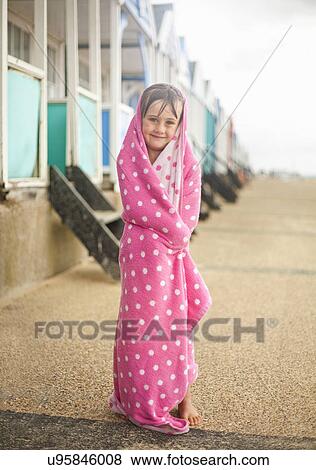 Portrait of young girl wrapped in blanket, Southwold, Suffolk, UK View Large Photo Image Stock Photo - Portrait of young girl wrapped in blanket, Southwold, Suffolk, UK. Fotosearch