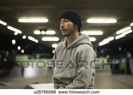 Portrait of young man wearing knit hat and hooded top View Large Photo Image Stock Photo - Portrait of young man wearing knit hat and hooded top. Fotosearch