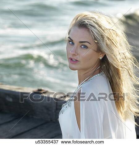 Portrait of young woman at coast View Large Photo Image Stock Photo - Portrait of young woman at coast. Fotosearch