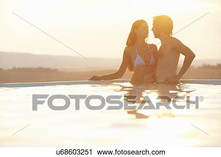 Romantic couple holding hands in outdoor swimming pool View Large Photo Image Stock Image - Romantic couple holding hands in outdoor swimming pool. Fotosearch