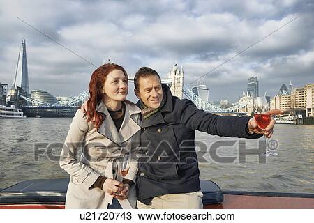 Romantic couple on Thames boat with pink champagne, London, UK View Large Photo Image Stock Image - Romantic couple on Thames boat with pink champagne, London, UK. Fotosearch