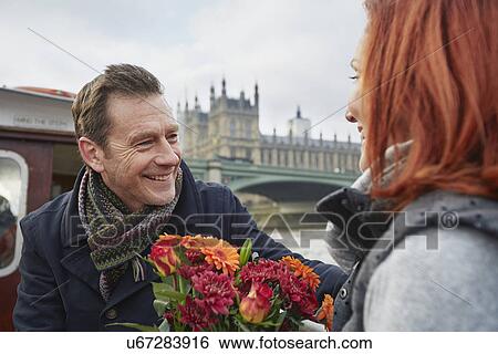 Romantic mature couple with bunch of flowers, London, UK View Large Photo Image Stock Photograph - Romantic mature couple with bunch of flowers, London, UK. Fotosearch