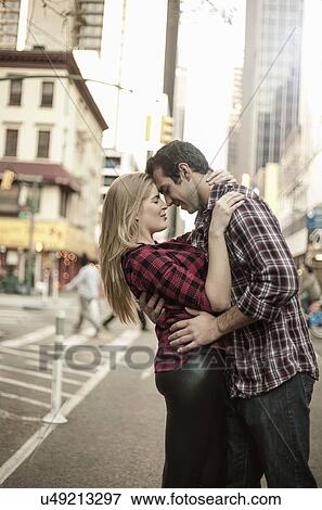 Stock Photo - Romantic young couple hugging on street, New York City, USA. Fotosearch