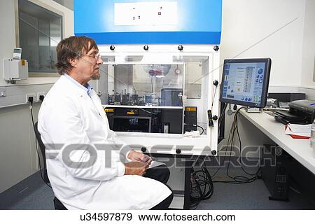Scientist working in lab with computer and scientific machine View Large Photo Image Stock Photo - Scientist working in lab with computer and scientific machine. Fotosearch