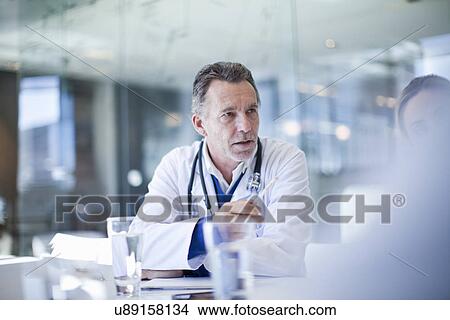 Picture - Senior doctor and colleagues meeting in conference room. Fotosearch