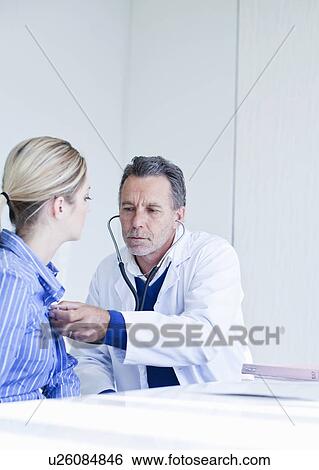 Senior male doctor taking listening to patients chest View Large Photo Image Stock Photograph - Senior male doctor taking listening to patients chest. Fotosearch