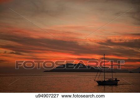 Stock Photo - Silhouetted boat at sunset, Fethiye, Turkey. Fotosearch