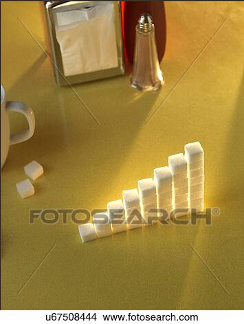 Stack of sugar cubes in the shape of a graph on a yellow table View Large Photo Image Picture - Stack of sugar cubes in the shape of a graph on a yellow table. Fotosearch