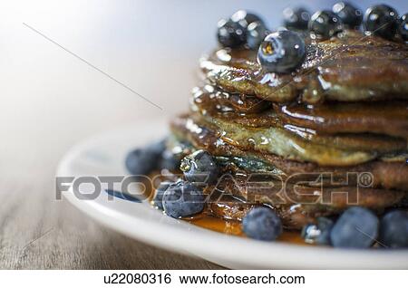Stock Photograph - Still life of blueberry pancakes with maple syrup. Fotosearch
