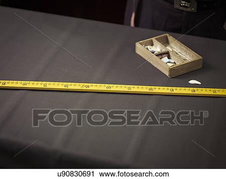 Stock Image - Still life of chalk and ruler in traditional tailors shop. Fotosearch