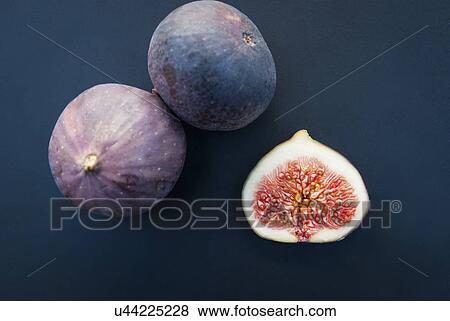 Still life of three figs, one sliced in half View Large Photo Image Stock Photo - Still life of three figs, one sliced in half. Fotosearch
