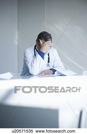 Stressed senior male doctor View Large Photo Image Stock Photography - Stressed senior male doctor. Fotosearch