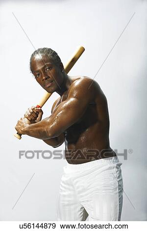 Studio portrait of baseball player holding up baseball bat View Large Photo Image Stock Photo - Studio portrait of baseball player holding up baseball bat. Fotosearch
