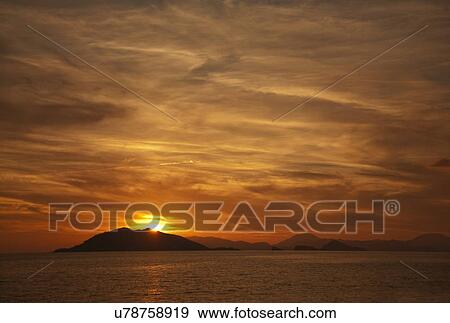 Stock Photo - Sunset over tranquil sea, Fethiye, Turkey. Fotosearch