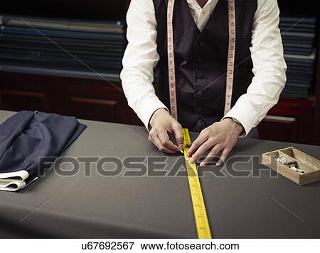 Tailor chalking measurements in traditional tailors shop View Large Photo Image Stock Photo - Tailor chalking measurements in traditional tailors shop. Fotosearch