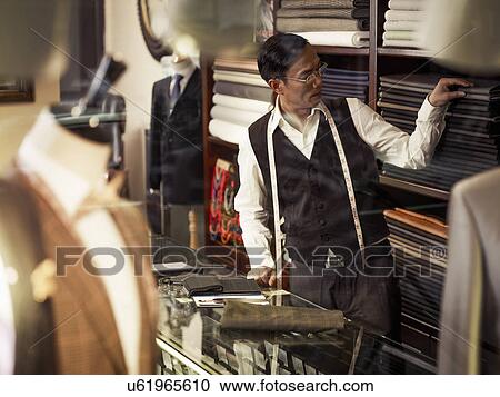 Tailor choosing fabric in traditional tailors shop View Large Photo Image Stock Image - Tailor choosing fabric in traditional tailors shop. Fotosearch