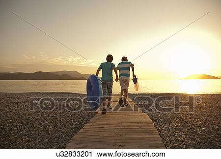 Teenage boy and brother running toward sea, Fethiye, Turkey View Large Photo Image Stock Image - Teenage boy and brother running toward sea, Fethiye, Turkey. Fotosearch