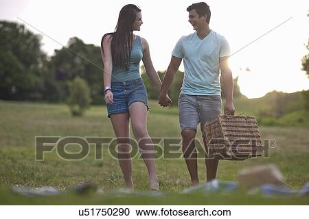 Teenage couple going for picnic in forest View Large Photo Image Stock Image - Teenage couple going for picnic in forest. Fotosearch