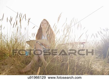 Teenage girl drawing on the beach View Large Photo Image Stock Photo - Teenage girl drawing on the beach. Fotosearch