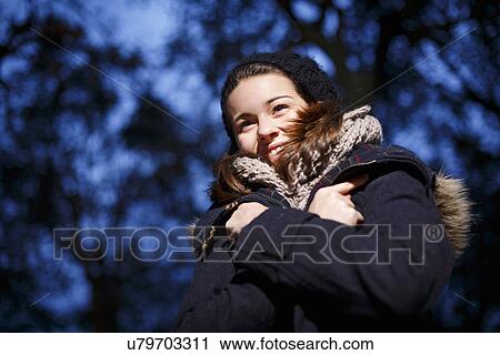 Stock Image - Teenage girl in forest at dusk. Fotosearch