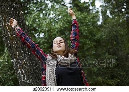 Teenage girl stretching in forest View Large Photo Image Stock Image - Teenage girl stretching in forest. Fotosearch