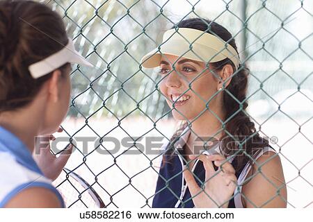 Stock Photograph - Tennis players talking at the fence. Fotosearch