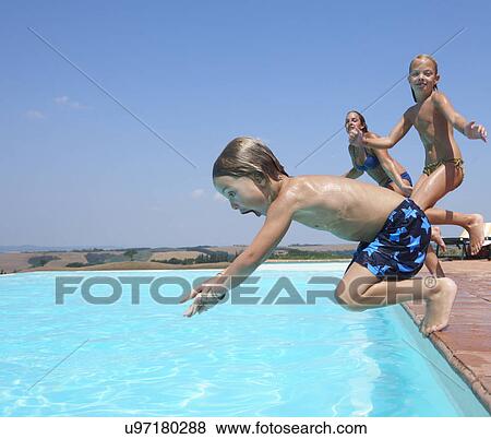 Three people jumping into swimming pool View Large Photo Image Stock Photo - Three people jumping into swimming pool. Fotosearch
