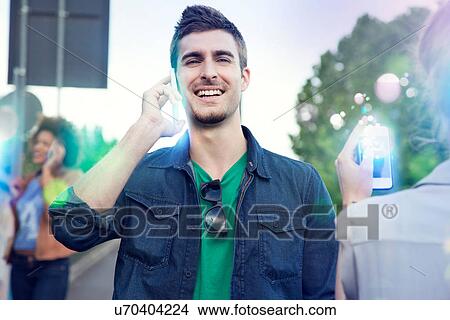 Three young adults using illuminated smartphones View Large Photo Image Picture - Three young adults using illuminated smartphones. Fotosearch