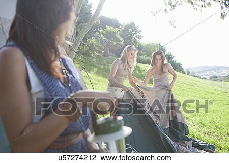 Three young female friends preparing tent for camping View Large Photo Image Stock Image - Three young female friends preparing tent for camping. Fotosearch