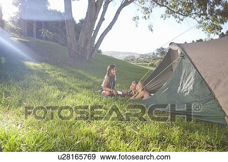 Three young females friends chatting at tent entrance View Large Photo Image Stock Photo - Three young females friends chatting at tent entrance. Fotosearch
