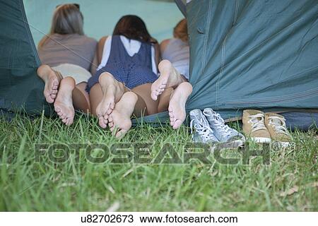 Three young females friends feet at tent entrance View Large Photo Image Stock Image - Three young females friends feet at tent entrance. Fotosearch