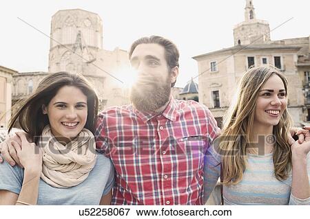 Three young tourists, Plaza de la Virgen, Valencia, Spain View Large Photo Image Stock Photo - Three young tourists, Plaza de la Virgen, Valencia, Spain. Fotosearch
