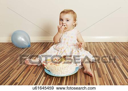 Toddler girl devouring birthday cake View Large Photo Image Stock Photo - Toddler girl devouring birthday cake. Fotosearch