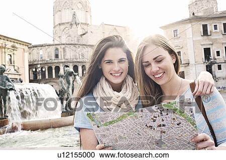 Two female tourists looking at map, Plaza de la Virgen, Valencia, Spain View Large Photo Image Stock Image - Two female tourists looking at map, Plaza de la Virgen, Valencia, Spain. Fotosearch