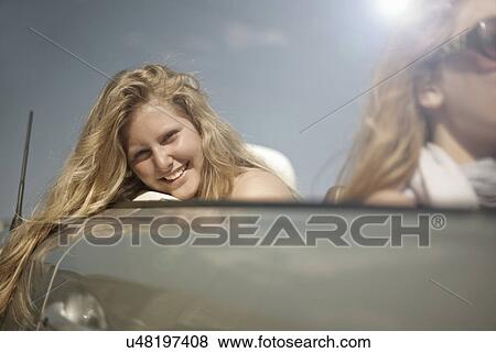 Two sisters having fun in sports convertible View Large Photo Image Stock Photo - Two sisters having fun in sports convertible. Fotosearch