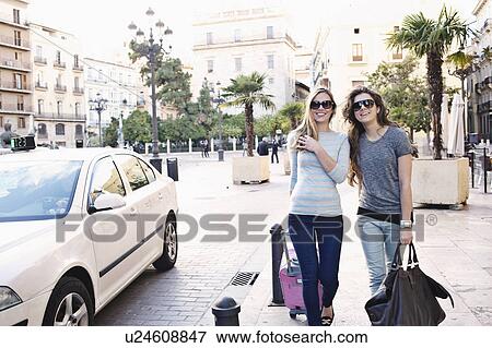 Two young female friends out shopping, Valencia, Spain View Large Photo Image Stock Photo - Two young female friends out shopping, Valencia, Spain. Fotosearch
