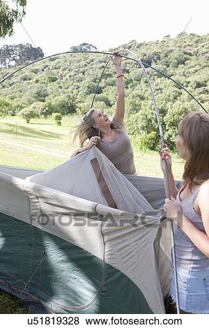Two young females friends constructing tent View Large Photo Image Stock Photo - Two young females friends constructing tent. Fotosearch