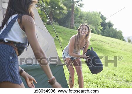 Two young females friends having fun whilst camping View Large Photo Image Stock Photograph - Two young females friends having fun whilst camping. Fotosearch